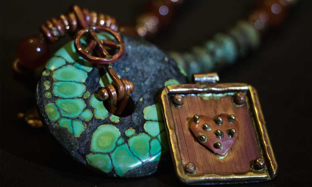 An ensemble of handmade copper pieces and turquoise in traditional Southwest design by Patricia Healey.